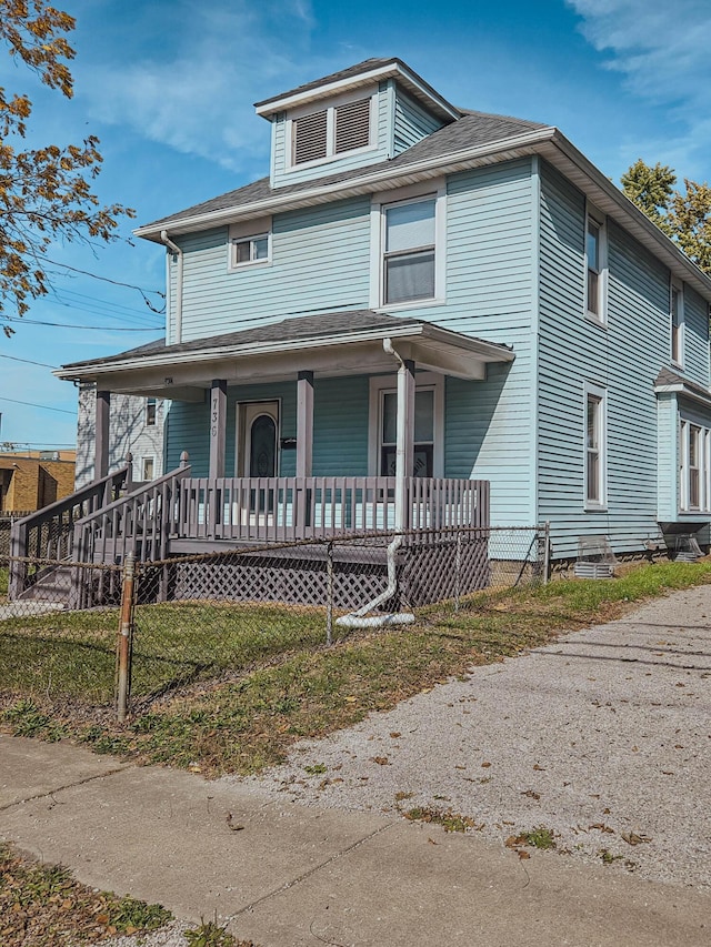 american foursquare style home with covered porch and fence