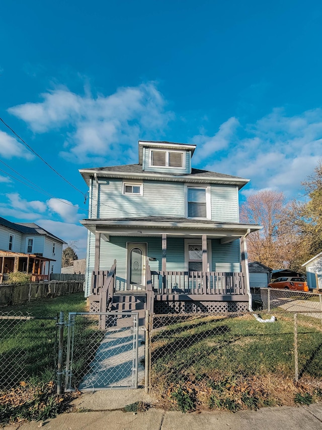 american foursquare style home with a porch, a fenced front yard, a front yard, and a gate