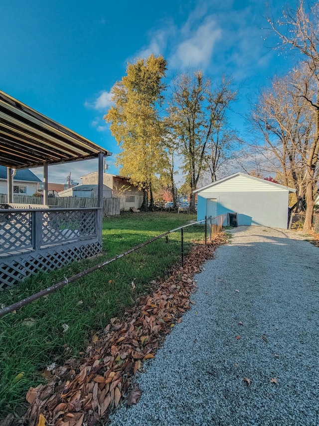 view of yard with fence and an outbuilding