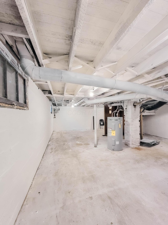 unfinished basement featuring water heater