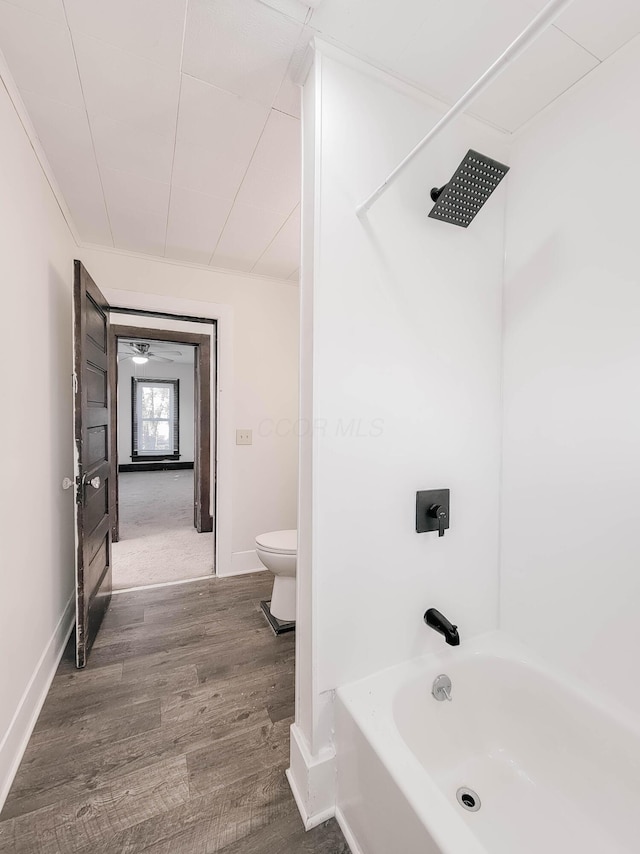 bathroom featuring toilet, baseboards, and wood finished floors