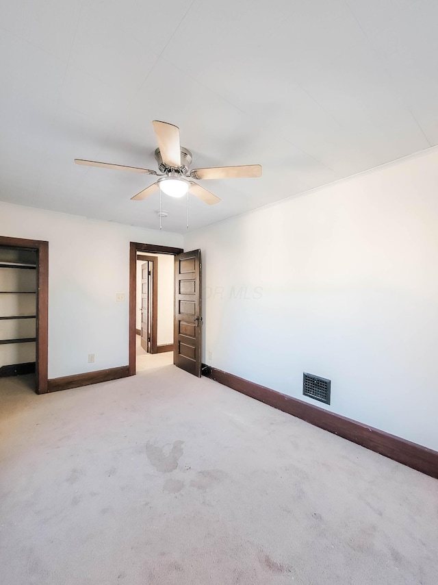 unfurnished bedroom featuring a ceiling fan, carpet, visible vents, and baseboards