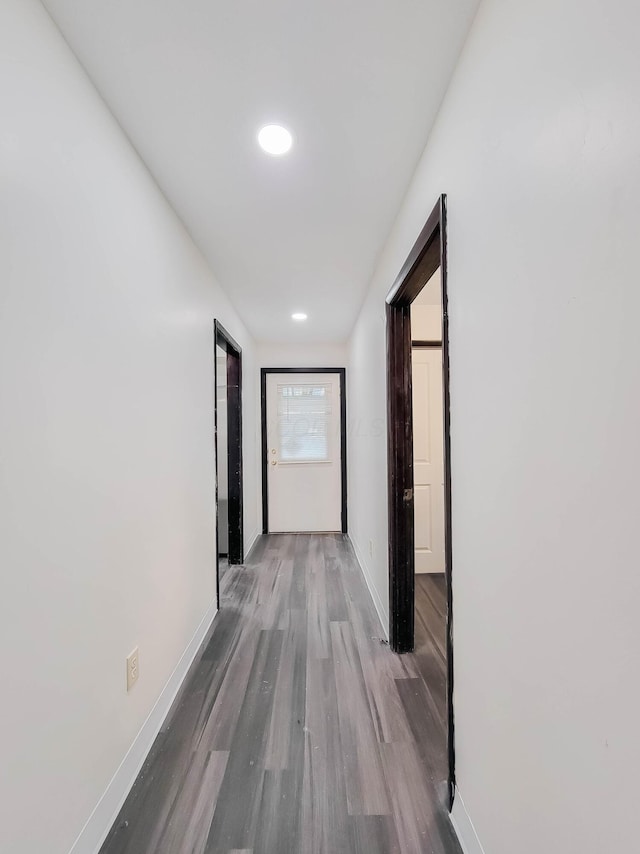 hall featuring recessed lighting, baseboards, and wood finished floors