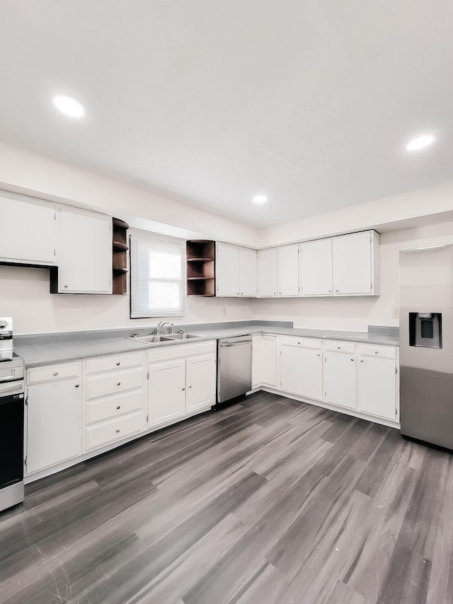 kitchen with a sink, stainless steel appliances, open shelves, and white cabinetry