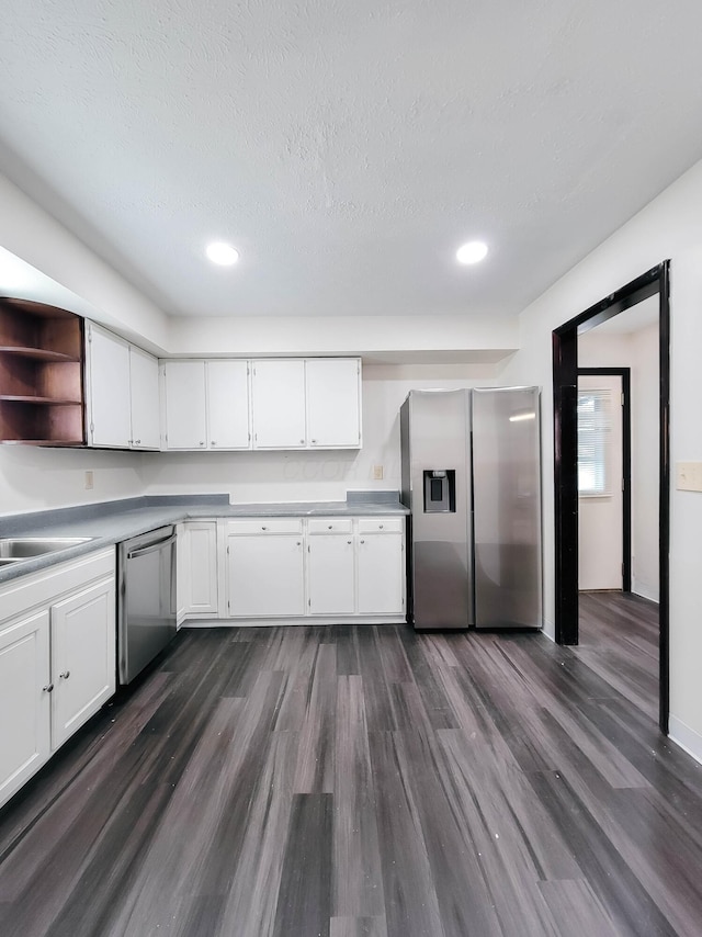 kitchen with white cabinets, appliances with stainless steel finishes, dark wood-style flooring, light countertops, and open shelves