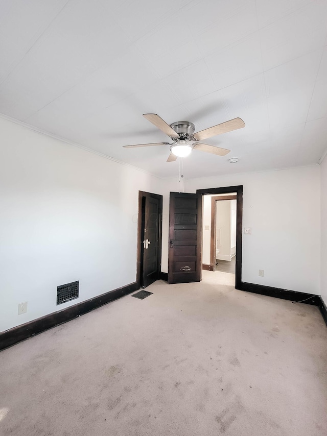 unfurnished bedroom featuring a ceiling fan, carpet flooring, visible vents, and baseboards