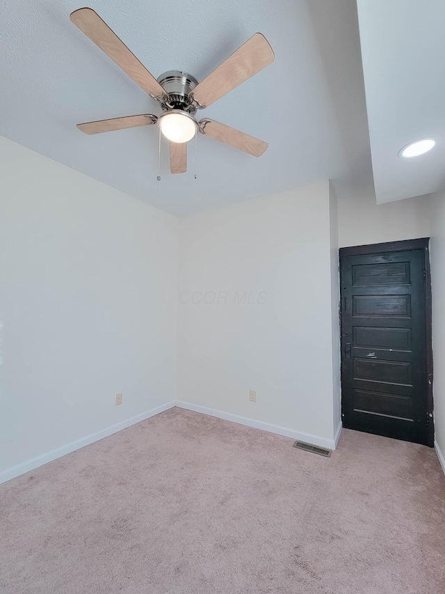 unfurnished bedroom featuring carpet floors, a ceiling fan, visible vents, and baseboards