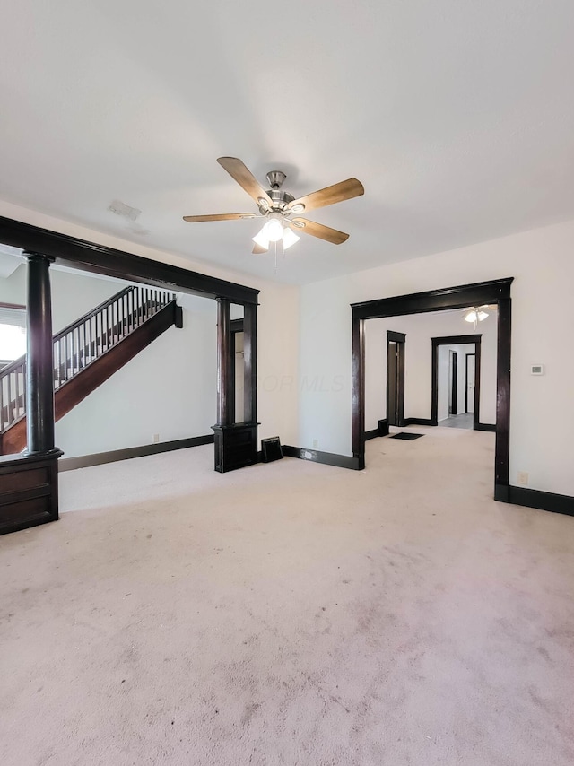 interior space featuring ceiling fan, stairway, and baseboards