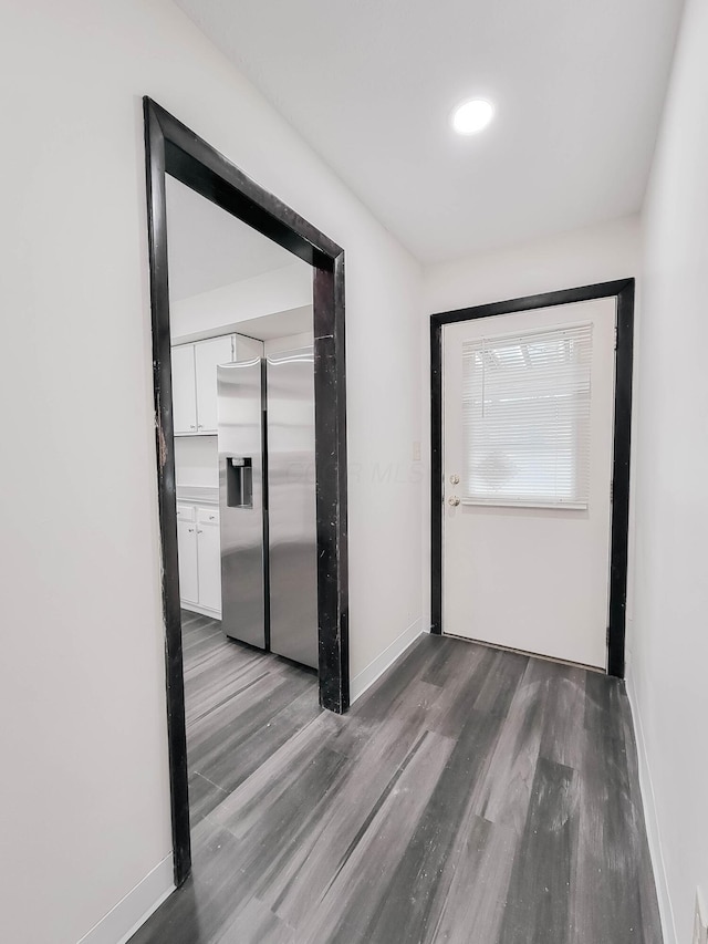 hall with wood finished floors and baseboards