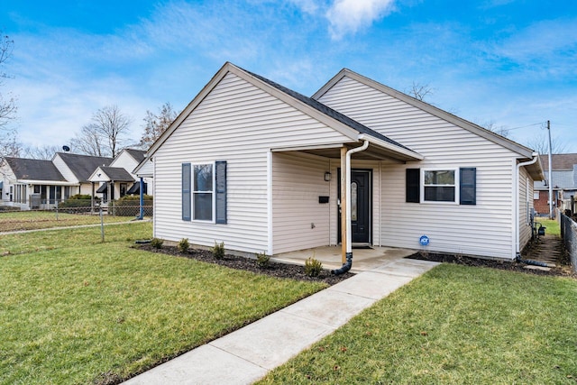 bungalow-style home featuring fence and a front lawn