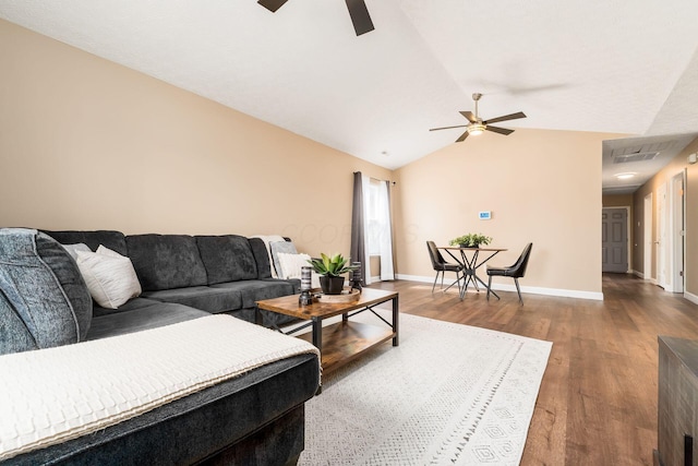 living room featuring a ceiling fan, lofted ceiling, baseboards, and wood finished floors