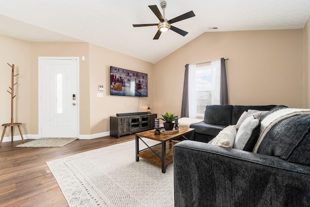 living room with visible vents, baseboards, a ceiling fan, lofted ceiling, and light wood-type flooring