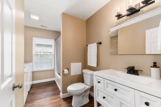 bathroom with baseboards, visible vents, toilet, wood finished floors, and vanity