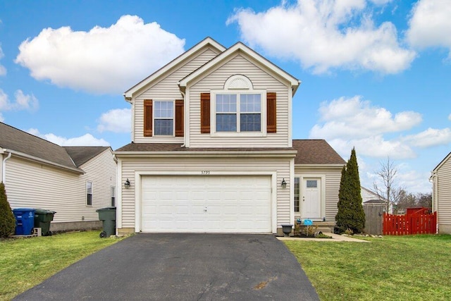 traditional home featuring a garage, driveway, a front lawn, and fence