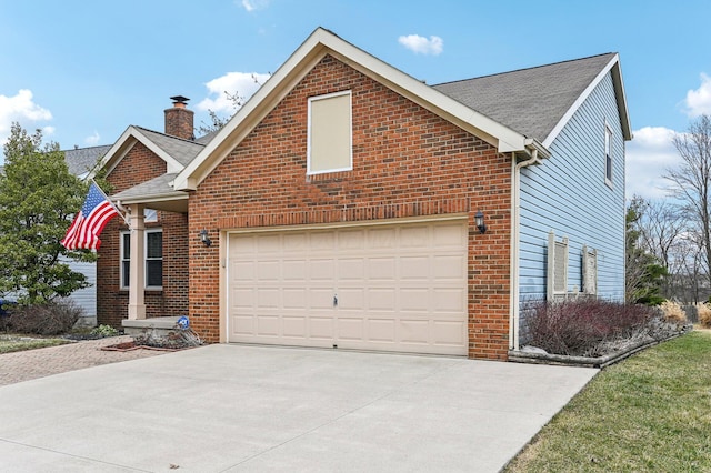 view of front of home featuring a garage, driveway, brick siding, and a chimney