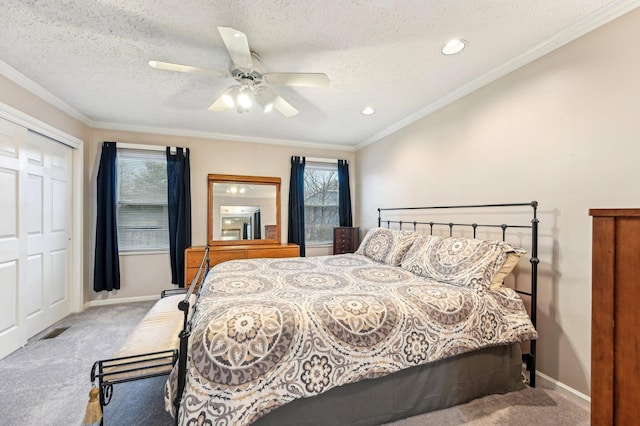 bedroom featuring a textured ceiling, baseboards, carpet flooring, and ornamental molding