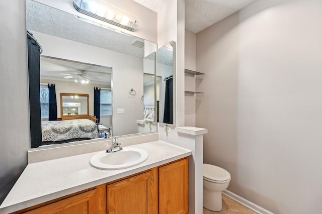 bathroom with toilet, vanity, ensuite bath, and a textured ceiling