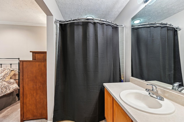 full bathroom with a textured ceiling, a shower with shower curtain, and vanity