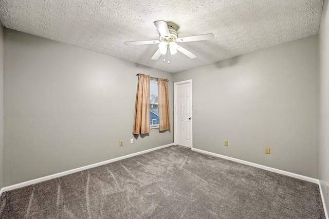 carpeted empty room featuring ceiling fan, a textured ceiling, and baseboards