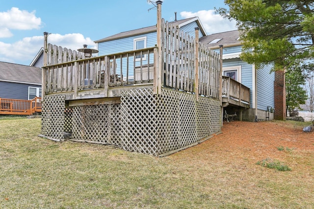 back of house featuring a yard and a wooden deck