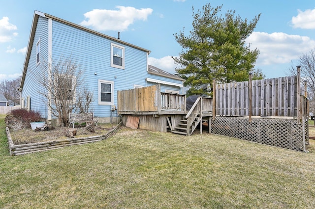 rear view of house with a lawn and a deck