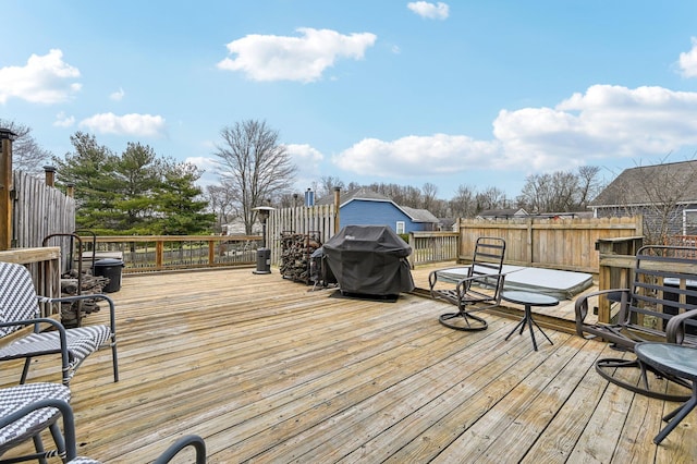 wooden terrace with a grill