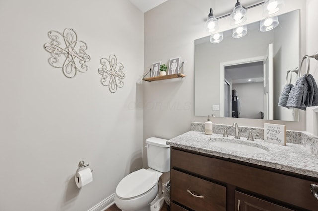 bathroom with toilet and vanity