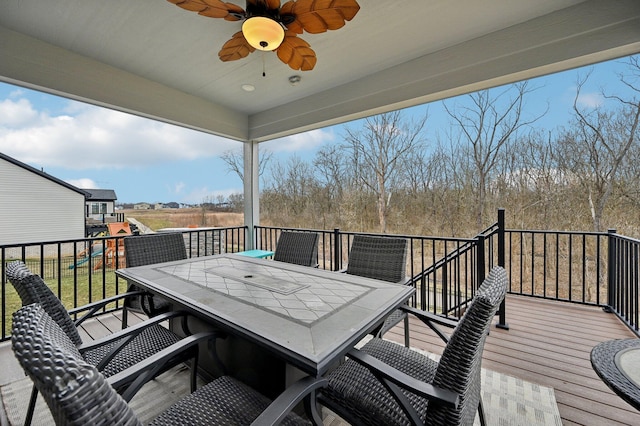 deck featuring outdoor dining area and a ceiling fan