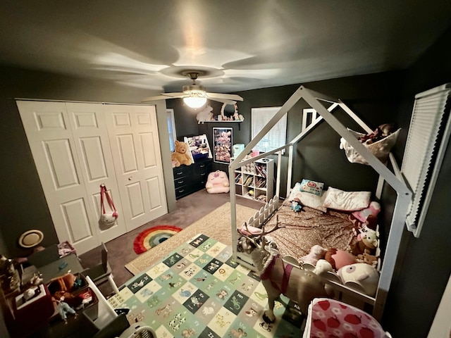 bedroom with ceiling fan and a closet