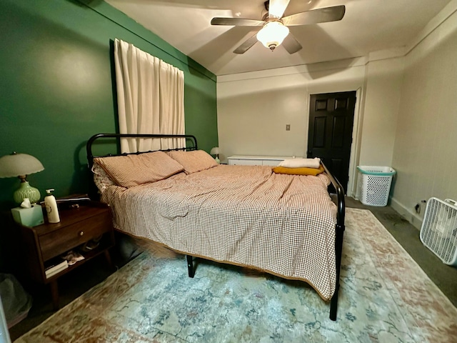 bedroom with a ceiling fan, carpet flooring, a baseboard heating unit, and baseboards