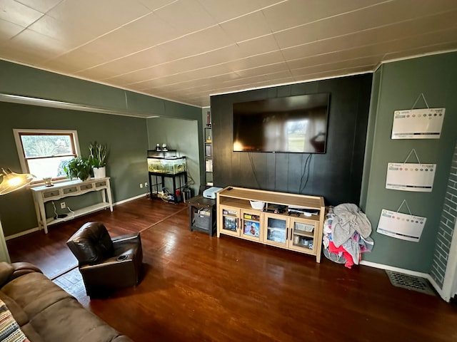 living area featuring baseboards and wood finished floors