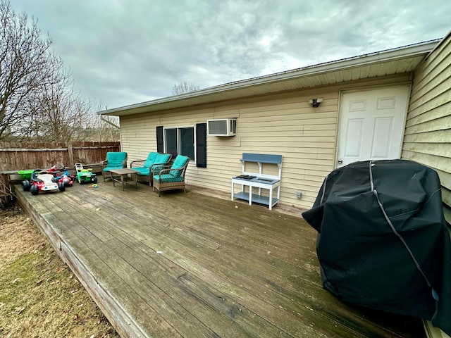 wooden terrace featuring a wall mounted AC, a grill, and fence