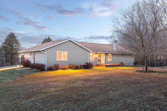 single story home featuring a front lawn and central AC