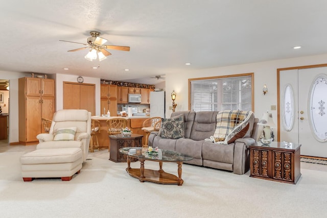 living room featuring recessed lighting, ceiling fan, and light colored carpet