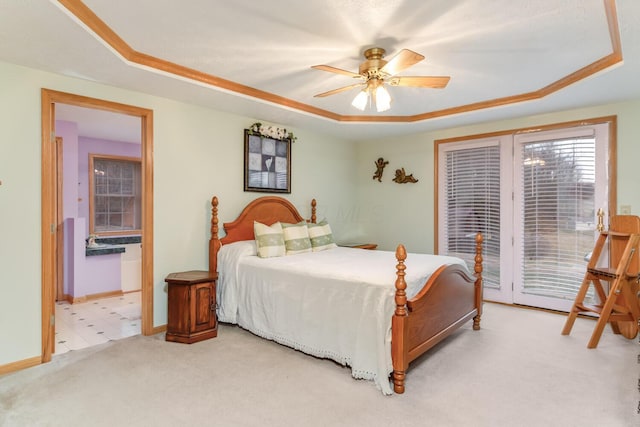 bedroom featuring ceiling fan, light colored carpet, baseboards, access to outside, and a tray ceiling