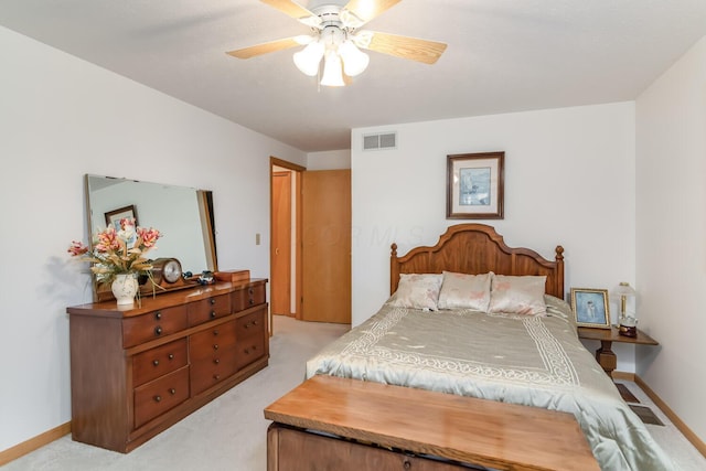 bedroom featuring a ceiling fan, light colored carpet, visible vents, and baseboards