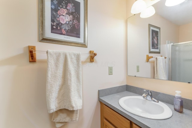 bathroom featuring a stall shower, visible vents, and vanity