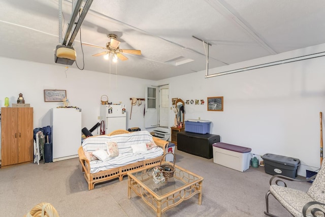 garage with a garage door opener, a ceiling fan, and freestanding refrigerator