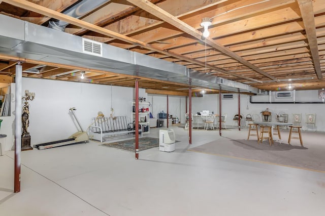 unfinished basement featuring visible vents