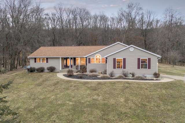 ranch-style house featuring a porch and a front lawn