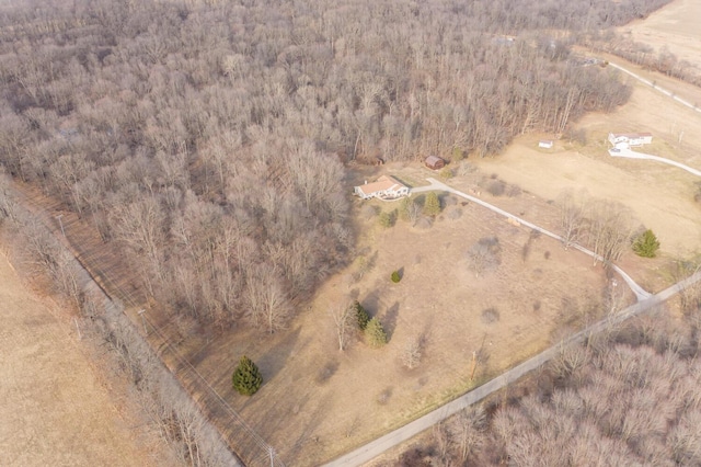 drone / aerial view with a wooded view