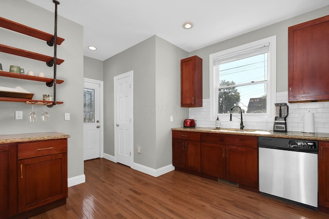 kitchen featuring dark wood-style floors, a sink, backsplash, and stainless steel dishwasher