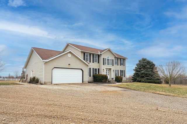 colonial-style house featuring a garage and driveway