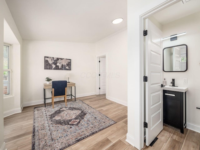 office area featuring light wood-style floors and baseboards