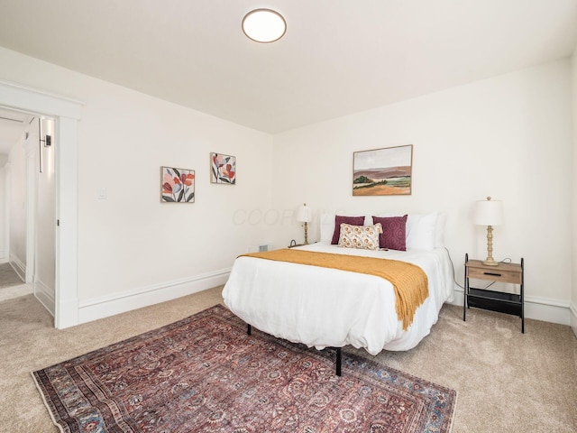 carpeted bedroom featuring baseboards