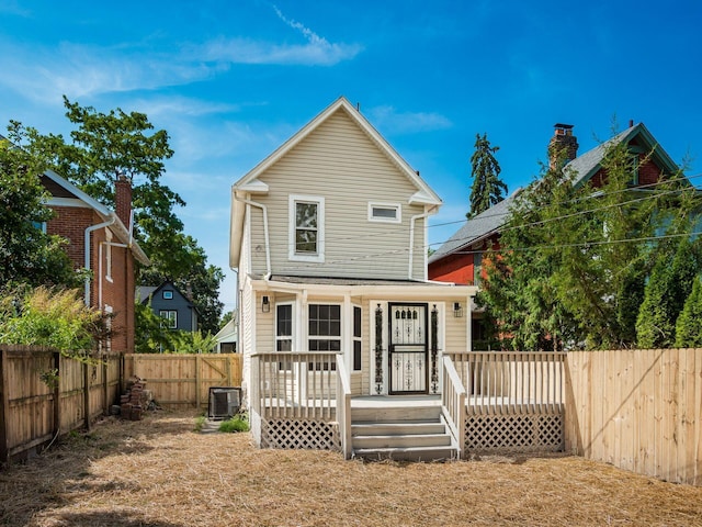 rear view of house with a fenced backyard and a wooden deck