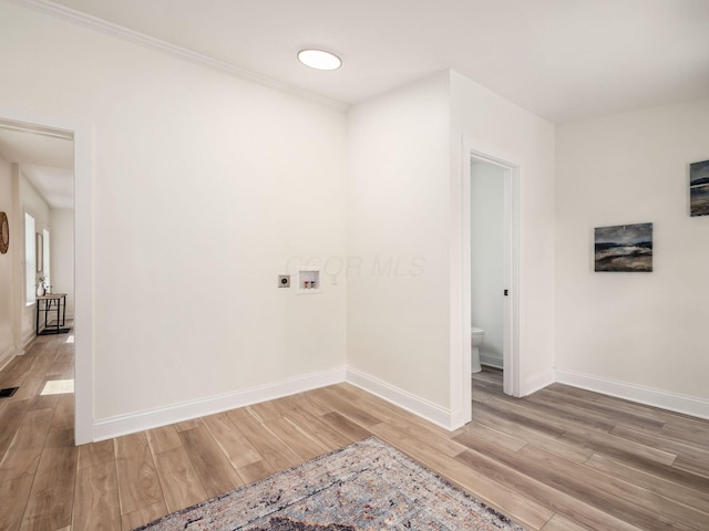 interior space with baseboards and wood finished floors