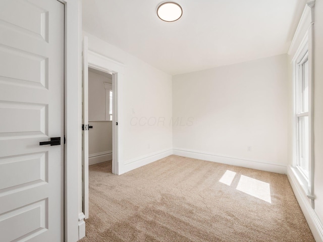 unfurnished room featuring baseboards and carpet flooring