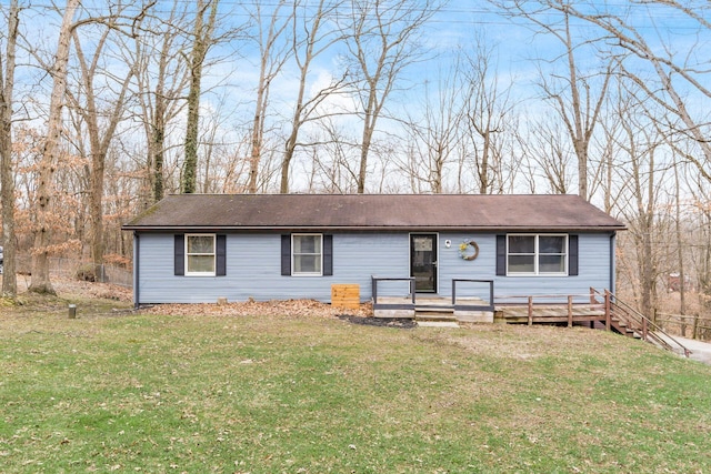 ranch-style home with a wooden deck and a front yard