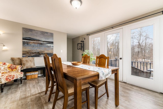 dining space with light wood-style flooring